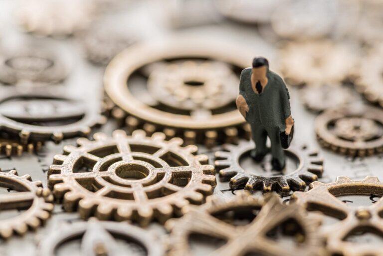 A man standing on a clockwork mechanism